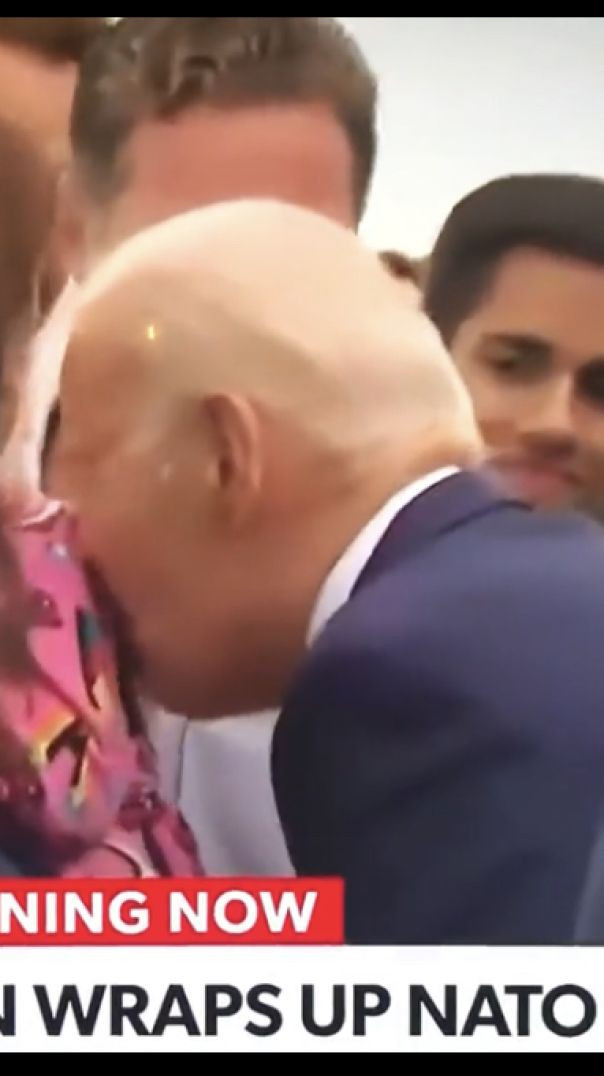 Biden sniffing childs hair